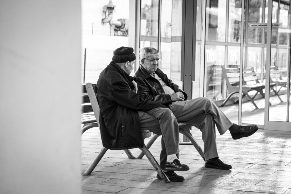 Elderly men in deep conversation at Eskişehir train station, Türkiye.